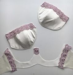 two white bras with pink trim on them