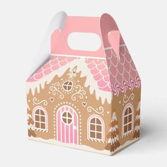 a paper box with a gingerbread house design on the front and side, sitting on a white surface