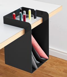 an office desk with several different colored pens and pencils in the holder on it