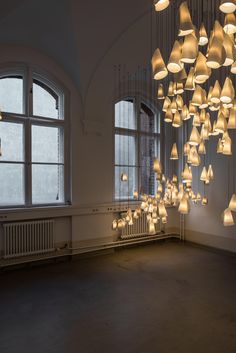 a large room with many lights hanging from the ceiling