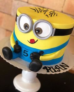 a yellow and blue cake sitting on top of a table