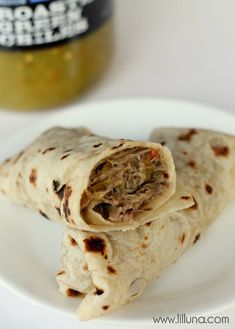 two burritos are on a white plate