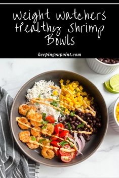 a bowl filled with shrimp, rice and beans