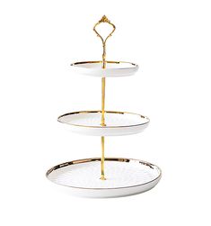 three tiered serving tray with gold trimmings on the bottom and two plates below