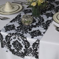 a table topped with white and black place settings