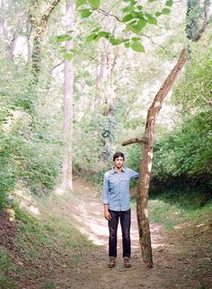 a man standing in the middle of a forest