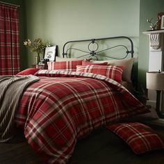 a red plaid comforter set on a bed