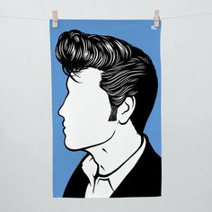 a drawing of a man's face on a blue background hanging from a clothes line