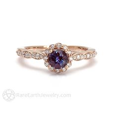 an engagement ring with a blue sapphire surrounded by white and rose gold pave diamonds