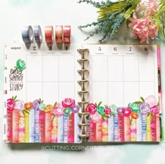 an open planner with washi tape and flowers