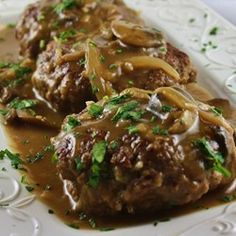 a white plate topped with meat covered in gravy