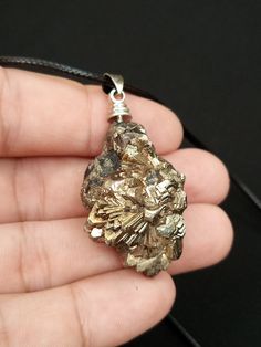 Pyrite is a beautiful and unique mineral that has been used for centuries in jewelry making. Its metallic luster and golden color make it a popular choice for creating stunning pendants that add a touch of elegance to any outfit. Our natural pyrite pendant is handcrafted with care and attention to detail, showcasing the natural beauty of this striking mineral. Pyrite Jewelry, Pyrite Pendant, Metallic Luster, Golden Color, Pendant Necklaces, Natural Beauty, Jewelry Necklace Pendant, Pakistan, Accessory Gift