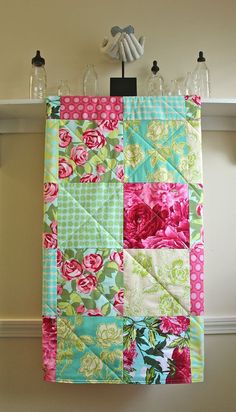 a colorful quilt hanging on the wall