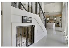 there is a dog gate on the wall next to the stairs in this house that has a sign reading, bad to the bone