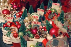 a table topped with lots of christmas decorations and ornaments on top of eachother