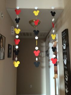 a hallway decorated with mickey mouse decorations and handprints on the ceiling above it