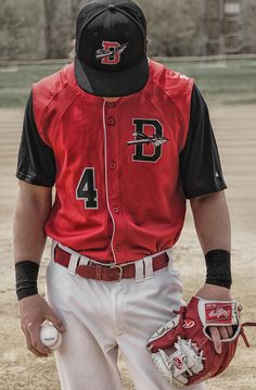 a baseball player wearing a catchers mitt and holding a ball