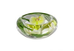 a glass bowl with flowers in it on a white background