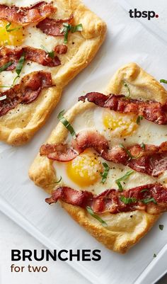 two pizzas with bacon and eggs on them sitting on top of a white plate