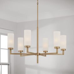 a chandelier with six lights hanging from it's sides in a room