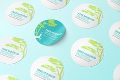 several circular stickers with trees and the words free mockup on them against a blue background