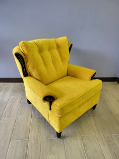 a yellow chair sitting on top of a hard wood floor