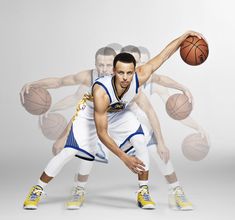 two basketball players in white and blue uniforms, one holding the ball with both hands