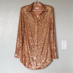 Camila Coelho Erika Gold Sequin Long Sleeve Shirt Dress - New With Tags - Revolve Style No. Coel-Wd307 - Size: Xs In Gold - Self: 95% Polyester, 5% Spandex - Lining: 100% Polyester - Hand Wash - Fully Lined - Front Button Closure - Padded Shoulders - Buttoned Cuffs - Sequined Embellishments Throughout - Approx. Measurements: 16" Pit To Pit, 14.25" Waist, 16" Hip, 14.5" Shoulder, Shoulder 25", 31.5" Length (Center - Hem) Fitted Long Sleeve Shirt Dress For Date Night, Fitted V-neck Shirt Dress For Party, Long Sleeve Blouse For Summer Cocktail Events, Spring Party Mini Dress Button-up, Sequin Long Sleeve Blouse For Date Night, Long Sleeve Sequin Blouse For Date Night, Chic Long Sleeve Shirt Dress For Party, Glamorous Long Sleeve Dress For Dress Down Occasions, Button-up Sequin Blouse For Party