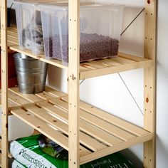 the shelves have plastic containers on them and some food is sitting on top of them