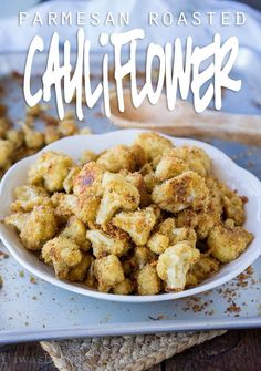 a white bowl filled with cauliflower on top of a table