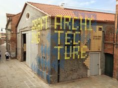 a building that has been painted with blue and yellow paint on it's side