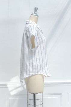 A staple of the French girl wardrobe, this carefree button-up blouse in blue and white striped cotton features a button-up front, rounded hem, and short, cuffed sleeves. Wear to work or with your favorite jeans for a no-effort French chic look! . Details: S: Bust 40", Length 23" M: Bust 42", Length 24" L: Bust 44", Length 25" Length Measured from Shoulder Unlined Material: 100% Cotton Imported Hand Wash Cold / Line Dry