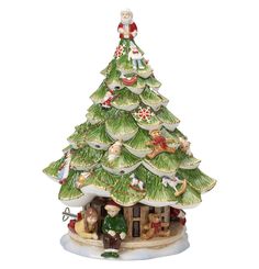 a ceramic christmas tree with people sitting on it's roof and around the base