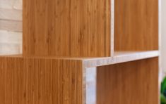 a close up of some wooden shelves with green vases in the backgroud