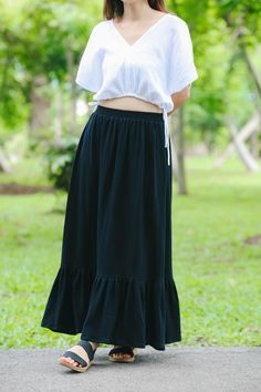 Size S-M Waist  24-32" Hips 34-42" Length 34" Size M-L Waist  32-40" Hips 42-50 Length 34" White color includes lining for modesty. Model is 5′2″ (158cm) tall with a 81cm/32″ bust, 69cm/27″ waist, 92cm/36″ hips Crafted from the finest double-layered muslin gauze, this skirt promises a delicate touch and an exquisite drape that flows gracefully with every step you take. The lightweight, breathable fabric ensures comfort and ease, making it perfect for warm days or layered looks in cooler weather. The skirt features a full-length design that exudes elegance and femininity. Its comfortable elastic waistband provides a flexible, snug fit, catering to a range of body types and sizes. The subtle texture of the gauze adds a rustic, yet sophisticated appeal, while the skirt's simplicity makes it a Spring Long Skirt With Ruffle Hem, Spring Maxi Skirt With Ruffles, Summer Ruffle Hem Midi Skirt, Casual Cotton Bottoms With Ruffle Hem, Fitted Casual Maxi Skirt With Ruffle Hem, Casual Fitted Maxi Skirt With Ruffle Hem, Solid Cotton Bottoms With Ruffles, Cotton Ruffled Skirt For Spring, Cotton Flowy Tiered Skirt