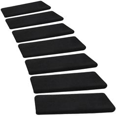 four black mats lined up on top of each other