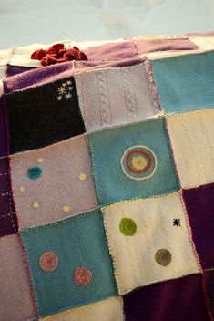 a patchwork blanket with various colored squares on it