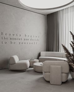 a living room filled with furniture and a quote on the wall next to a window