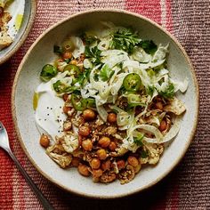 a white bowl filled with food on top of a table