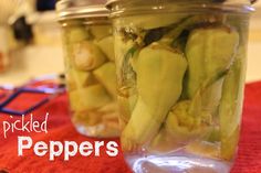 pickled peppers in a glass jar on a red tablecloth with the words pickled peppers