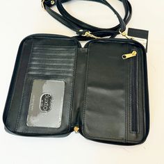 Carry Your Essentials In Style With This Julia Buxton Everywhere Rfid-Blocking Cell Phone Crossbody Bag. Product Features 7"H X 4"W X 1.5"D Adjustable Crossbody Strap Length: 18"-30" Zipper Closure Gold-Tone Hardware Interior: 3-Sided Zipper Opens To 6 Credit Card Slots, 2 Slip Pockets, An I.D. Window And Zipper Pocket Exterior: Outside Cell Phone Pocket With A Clear Front Rfid-Blocking Technology Safeguards Credit And Debit Cards From Unauthorized Scanning Black Construction & Care Body: Vegan Leather Lining: Polyester Blot Clean With Damp Cloth Black Travel Wallet Crossbody, Debit Cards, Crossbody Wallet, 7 H, Crossbody Strap, Card Slots, Product Features, Zipper Pocket, Vegan Leather