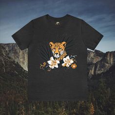 Immerse yourself in the beauty of nature with our Cheetah in Brush Wildflowers T-Shirt. This tastefully designed shirt features a cheetah amidst lush brush and wildflowers, offering a stylish and nature-inspired look. Available in a wide array of colors and sizes, this t-shirt is the perfect choice for those seeking a distinctive and elegant addition to their wardrobe. #7 Animal Classic unisex jersey short sleeve tee fits like a well-loved favorite. Soft cotton and quality print make users fall in love with it over and over again. Ribbed knit collars to bolster shaping. Shoulders are tapered for a better fit over time. Dual side seams hold the garment's shape for longer. Fabric Details Made with 100% Airlume combed and ring-spun cotton, a lightweight fabric (4.2 oz/yd² (142 g/m²)) that is Nature-inspired T-shirt With Plants Print For Summer, Nature-inspired Summer T-shirt With Plant Print, Summer Nature-inspired Crew Neck T-shirt, Nature-inspired Short Sleeve T-shirt For Summer, Nature-inspired Crew Neck T-shirt For Summer, Cheetahs, Prism Color, Fabric Details, Flower Fashion