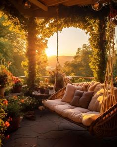 the sun is setting on an outdoor porch swing