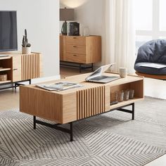 a living room scene with focus on the coffee table and entertainment center in the background