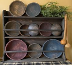 an old wooden rack with many plates on it