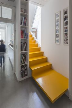 the stairs are painted bright yellow in this modern home