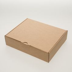 an open cardboard box sitting on top of a white surface with no one around it