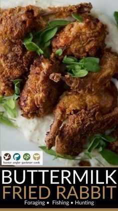 a plate with some fried chicken on top of rice and garnished with green leaves