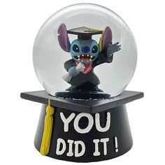 a toy figurine in a glass ball with the words you did it inside