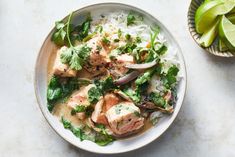 a white bowl filled with meat and vegetables on top of rice next to an avocado